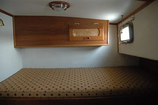 Slide: The Image of Cozy cabin interior of 2000 Willard Marine 40 Flybridge Sedan Trawler with wooden accents. - 16