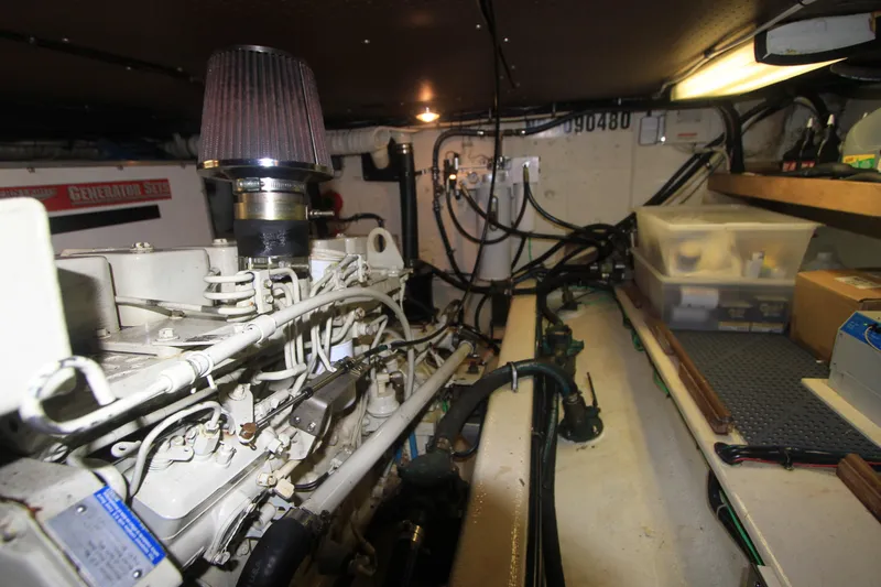 Slide: The Image of Engine room of 2000 Willard Marine 40 Flybridge Sedan Trawler with visible generator and storage. - 17