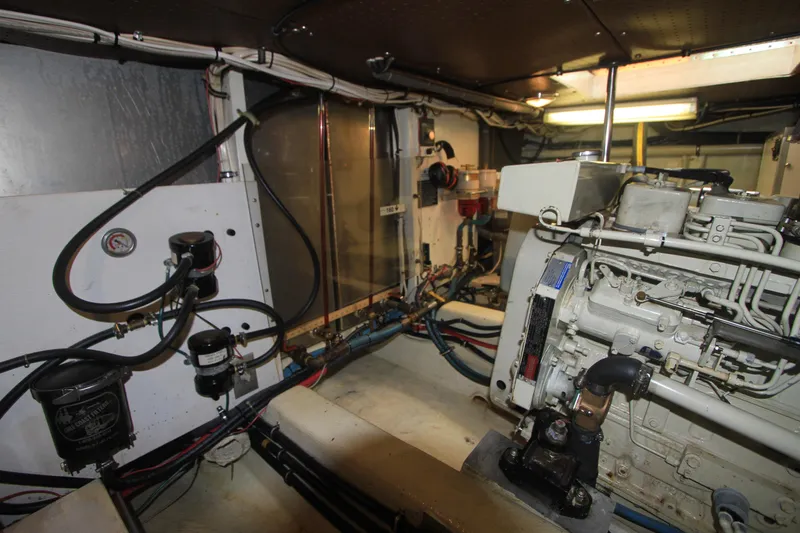 Slide: The Image of Engine room of 2000 Willard Marine 40 Flybridge Sedan Trawler, showcasing mechanical components. - 19