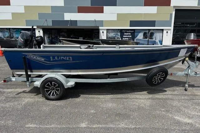 The Image of 2025 Lund 1675 Alaskan Tiller boat on trailer, parked outside a dealership. - 0