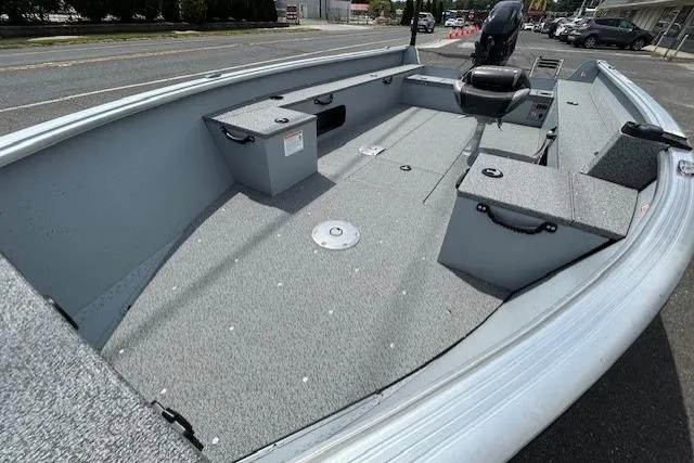 Slide: The Image of 2025 Lund 1675 Alaskan Tiller boat interior, spacious deck, storage compartments, and motor. - 10