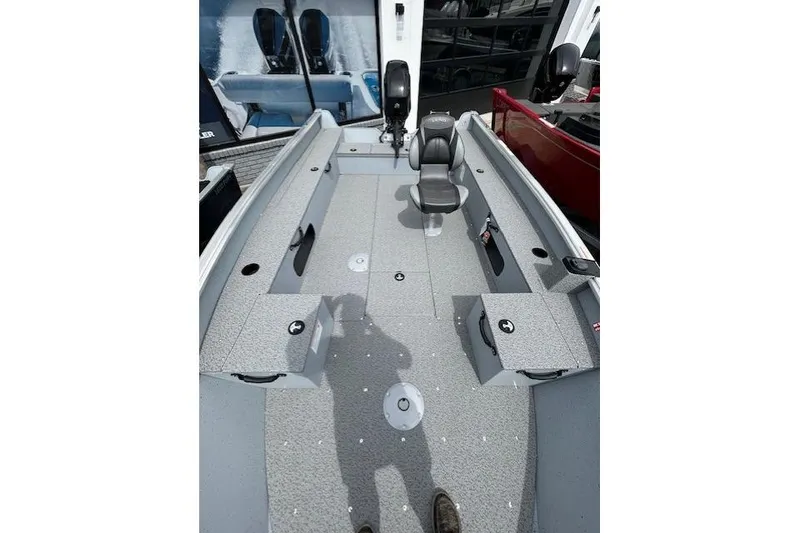 Slide: The Image of 2025 Lund 1675 Alaskan Tiller boat interior with seating and storage compartments. - 16