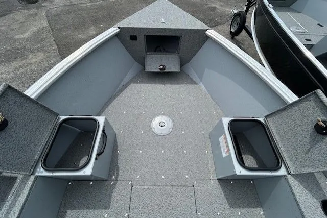 Slide: The Image of 2025 Lund 1675 Alaskan Tiller boat interior with storage compartments open. - 17