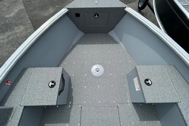 Slide: The Image of 2025 Lund 1675 Alaskan Tiller boat interior with gray seating and storage compartments. - 20