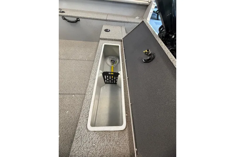 Slide: The Image of 2025 Lund 1675 Alaskan Tiller boat interior with open storage compartment. - 23