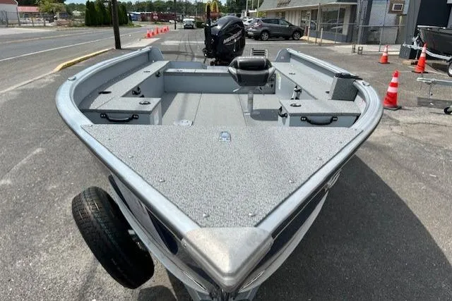 Slide: The Image of 2025 Lund 1675 Alaskan Tiller boat on display in a parking lot. - 6