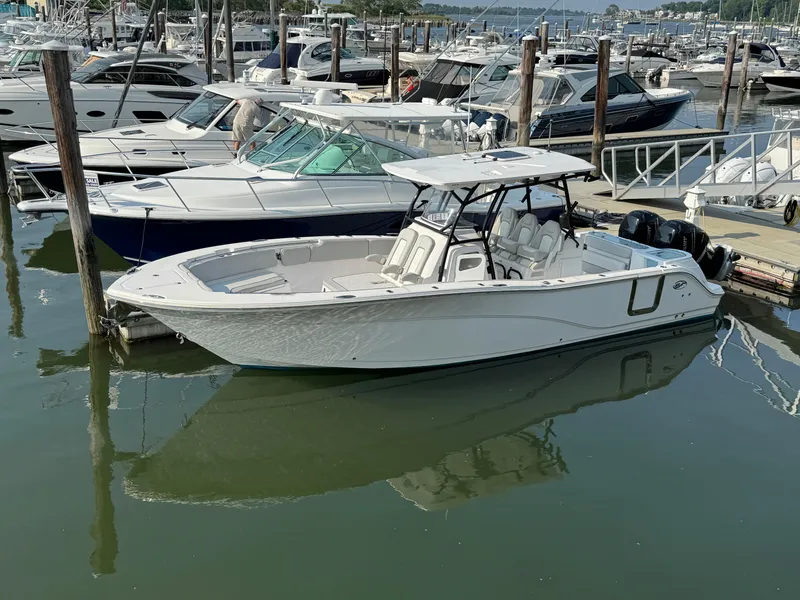 Slide: The Image of 2022 Sea Fox 328 Commander boat docked in a marina with other vessels. - 18