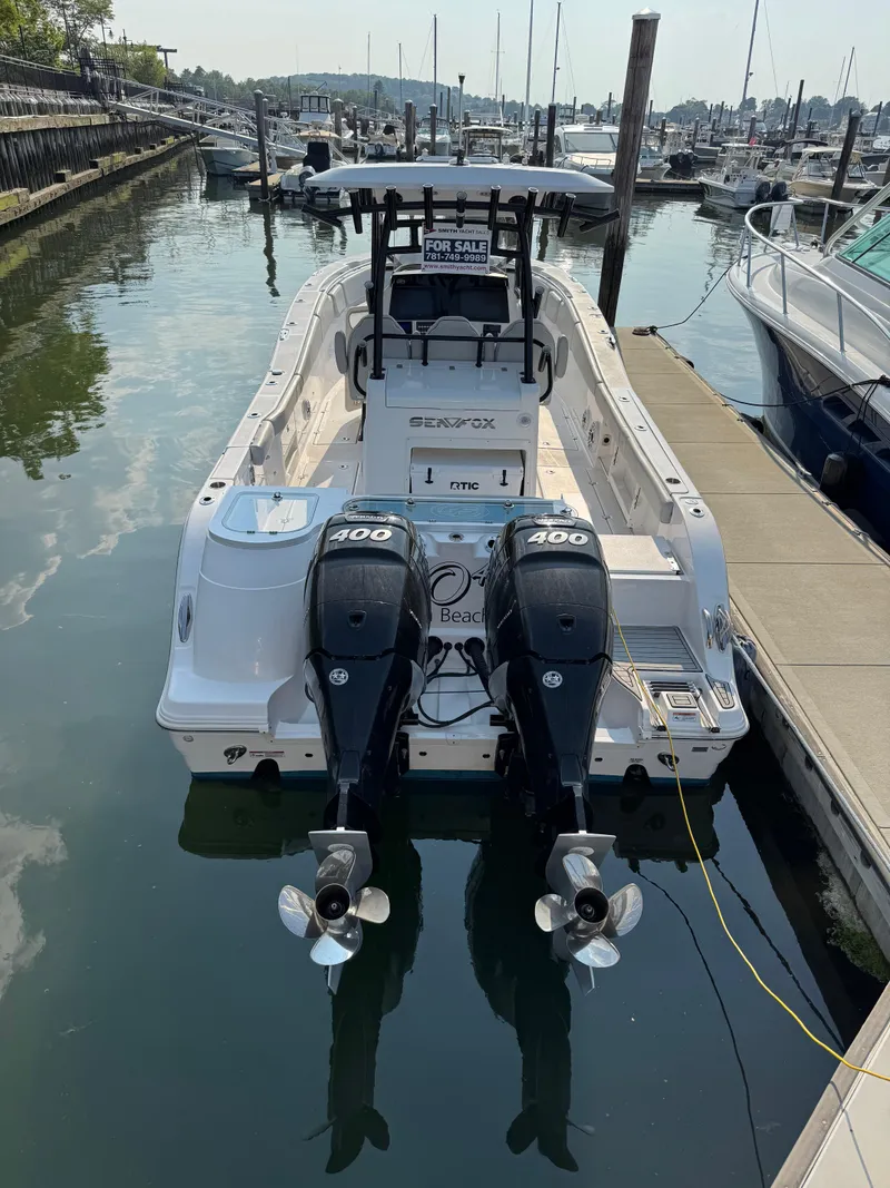 Slide: The Image of 2022 Sea Fox 328 Commander boat with twin 400 engines docked at marina. - 21