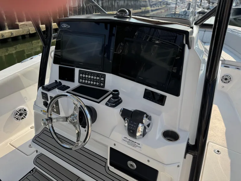 Slide: The Image of 2022 Sea Fox 328 Commander boat dashboard with steering wheel and electronic controls. - 23