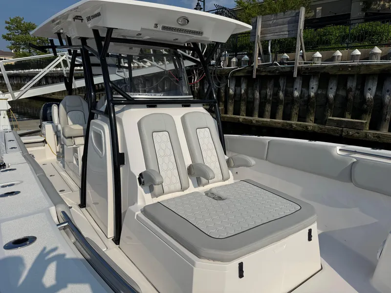 Slide: The Image of 2022 Sea Fox 328 Commander boat with cushioned seating and sleek design. - 28