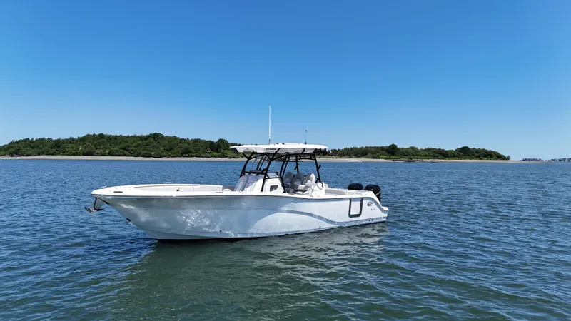 Slide: The Image of 2022 Sea Fox 328 Commander boat on calm water with clear blue sky. - 4