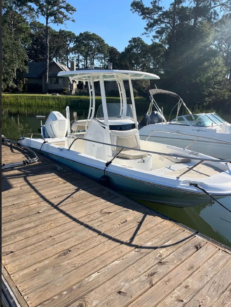 Slide: The Image of 2019 Boston Whaler 210 Dauntless boat docked on a sunny day. - 4