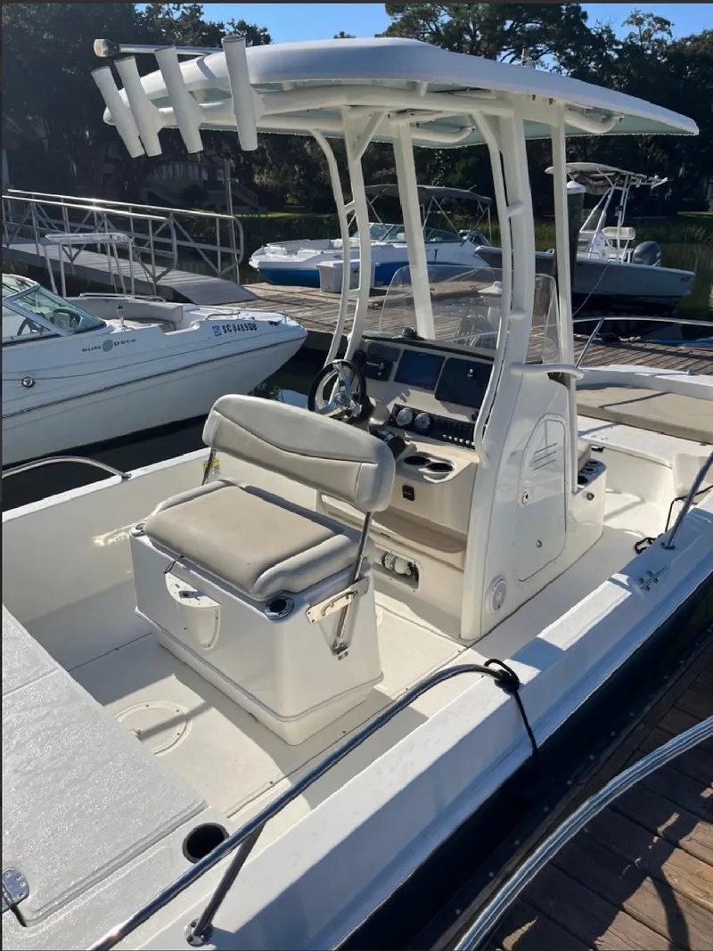 Slide: The Image of 2019 Boston Whaler 210 Dauntless boat with center console and seating, docked at marina. - 7