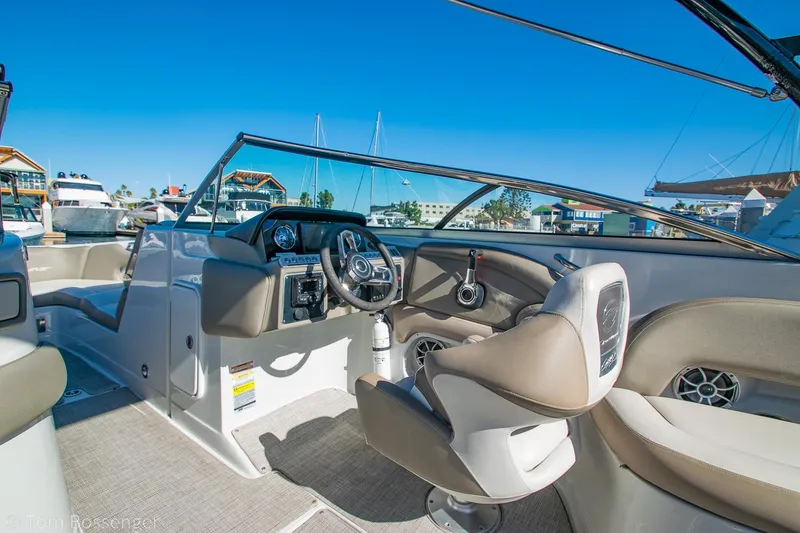 Slide: The Image of 2021 Crownline 255 XSS boat interior with steering wheel and seating. - 10
