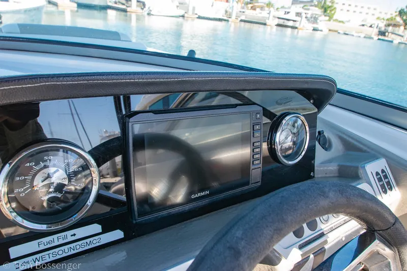 Slide: The Image of Dashboard of 2021 Crownline 255 XSS boat with Garmin display and gauges. - 14