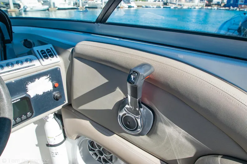 Slide: The Image of Interior of 2021 Crownline 255 XSS boat with control panel and throttle lever. - 17