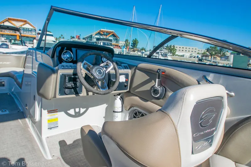 Slide: The Image of 2021 Crownline 255 XSS boat interior with steering wheel and dashboard. - 18