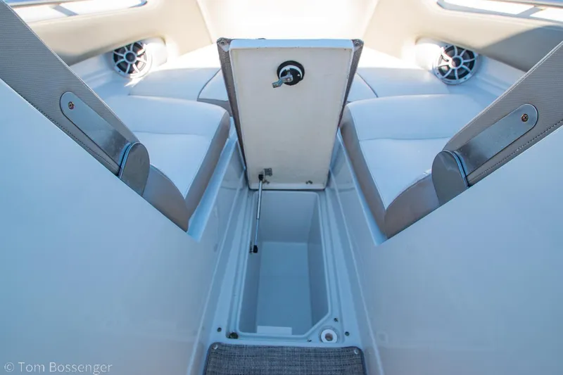 Slide: The Image of 2021 Crownline 255 XSS boat interior with open storage compartment and seating. - 20