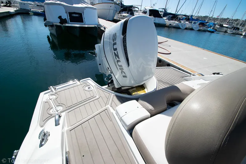 Slide: The Image of 2021 Crownline 255 XSS boat with Suzuki outboard motor docked at marina. - 22