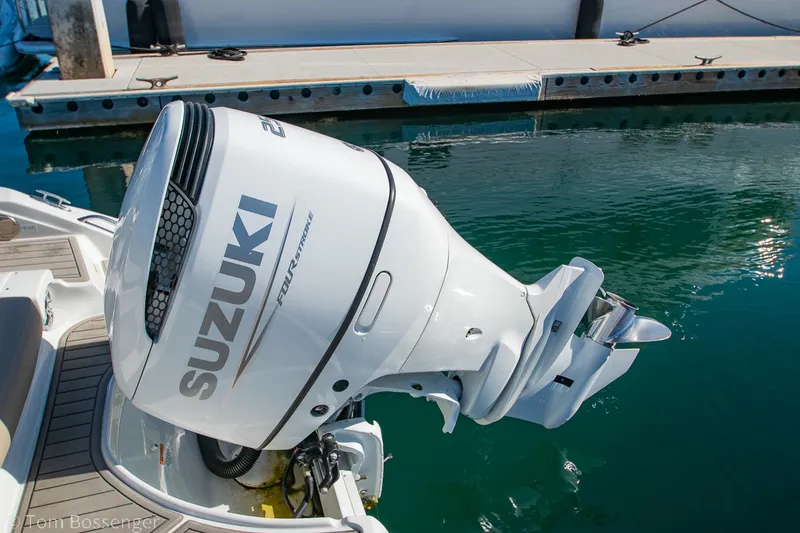 Slide: The Image of 2021 Crownline 255 XSS with Suzuki outboard motor at dock. - 23