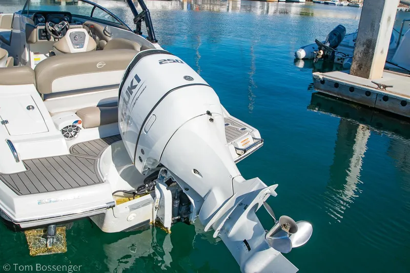 Slide: The Image of 2021 Crownline 255 XSS boat with Suzuki outboard engine docked in marina. - 24