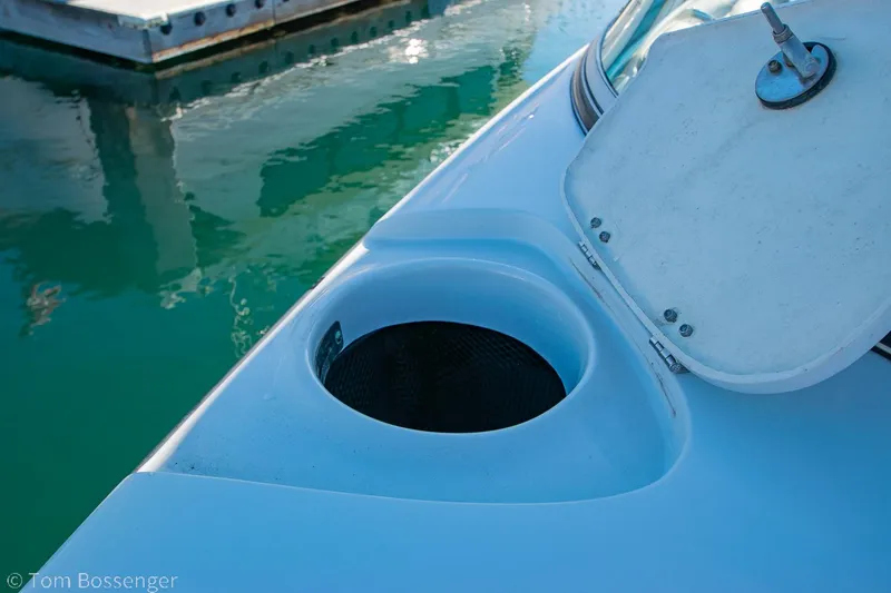 Slide: The Image of 2021 Crownline 255 XSS boat detail with open hatch and water view. - 26