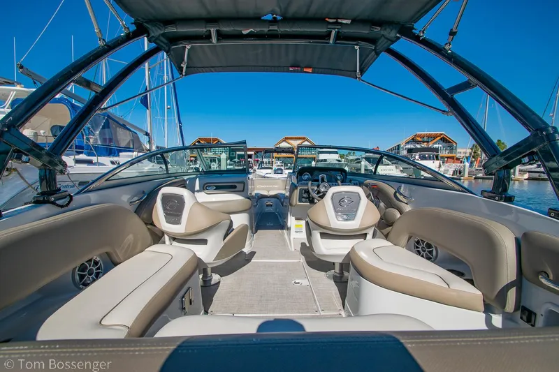 Slide: The Image of 2021 Crownline 255 XSS boat interior with beige seating and modern dashboard. - 5
