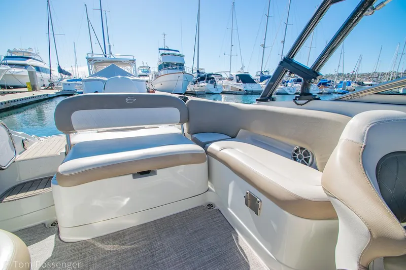 Slide: The Image of 2021 Crownline 255 XSS boat interior with comfortable seating at marina. - 7