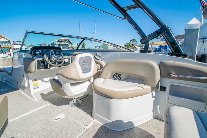 Slide: The Image of 2021 Crownline 255 XSS boat interior with beige seating and modern dashboard. - 8
