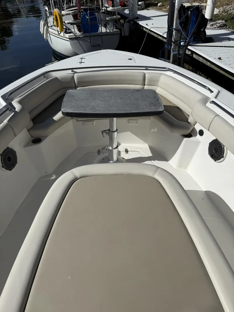 Slide: The Image of 2020 Boston Whaler 330 Outrage boat interior with seating and table. - 15