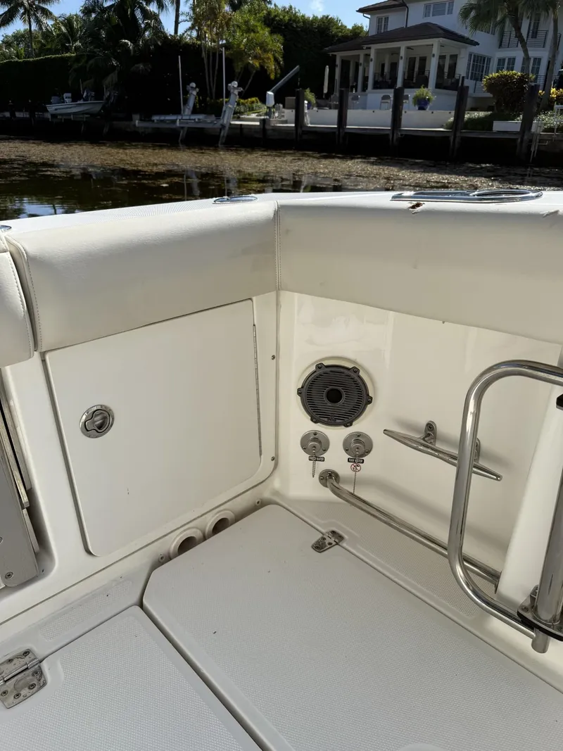 Slide: The Image of Boston Whaler 330 Outrage 2020 boat interior with seating and speaker, dockside view. - 22