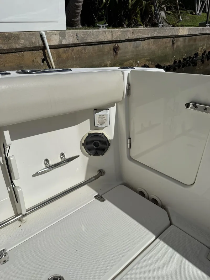 Slide: The Image of 2020 Boston Whaler 330 Outrage boat interior with seating and storage compartment. - 23
