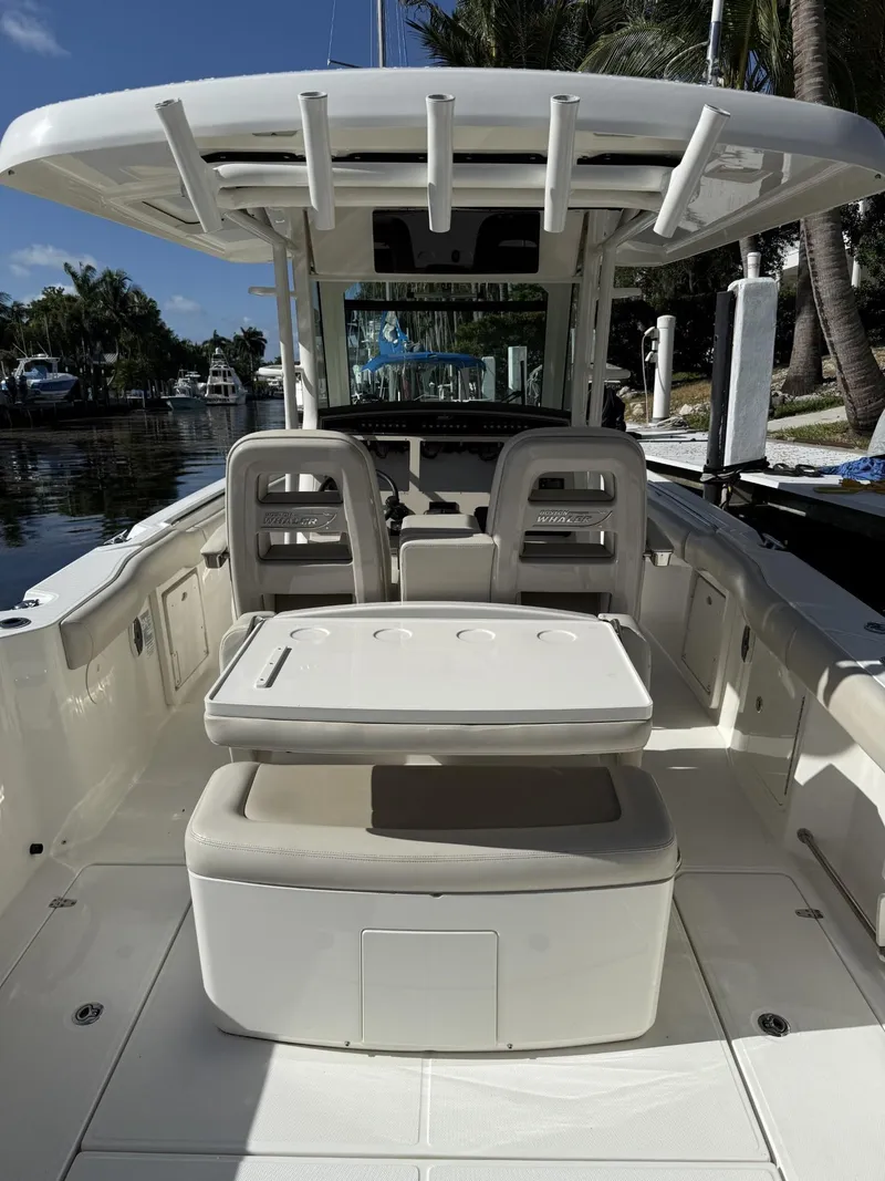 Slide: The Image of 2020 Boston Whaler 330 Outrage boat interior with seating and helm station. - 29