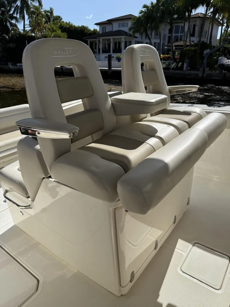 Slide: The Image of 2020 Boston Whaler 330 Outrage boat seating, featuring luxurious beige upholstery. - 31