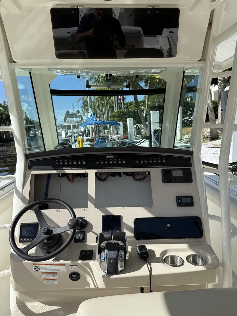 Slide: The Image of 2020 Boston Whaler 330 Outrage helm with steering wheel and control panel. - 32