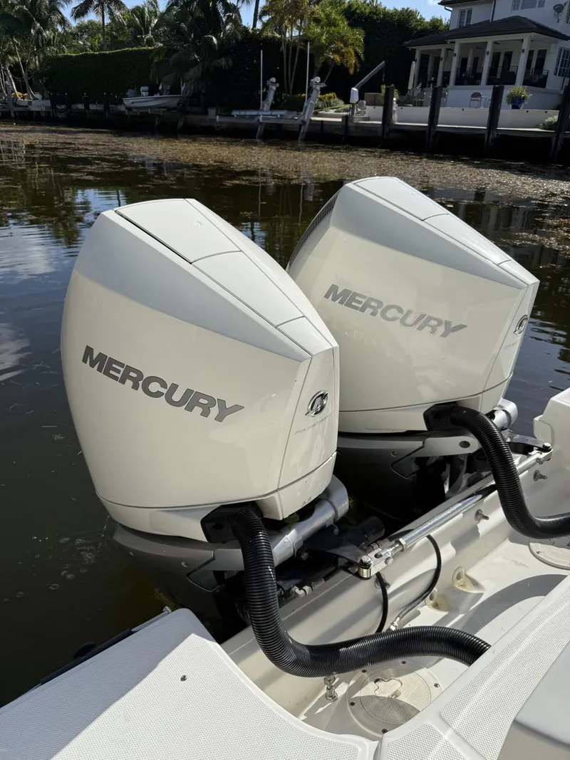 Slide: The Image of Twin Mercury outboard engines on a 2020 Boston Whaler 330 Outrage boat. - 35