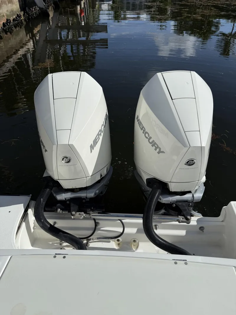 Slide: The Image of Twin Mercury outboard engines on a 2020 Boston Whaler 330 Outrage boat. - 36