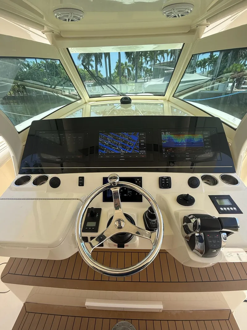 Slide: The Image of Helm of 2019 Scout 420 LXF boat with advanced navigation controls and steering wheel. - 20