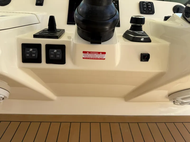 Slide: The Image of 2019 Scout 420 LXF boat interior with control panel and navigation equipment. - 26