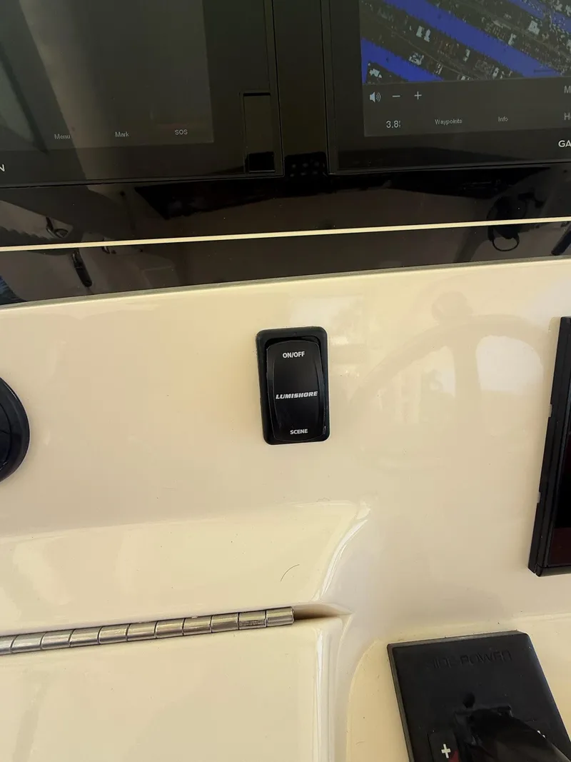 Slide: The Image of Control panel of 2019 Scout 420 LXF boat with Garmin display and switches. - 31