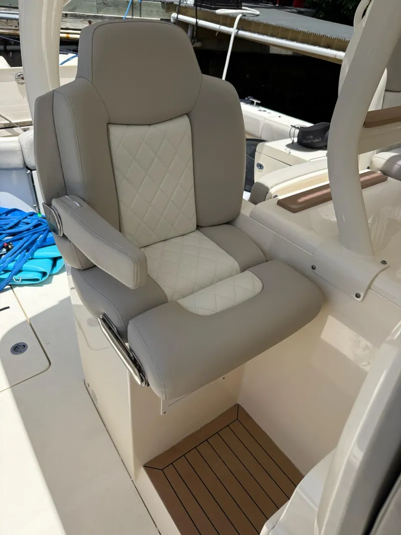 Slide: The Image of 2019 Scout 420 LXF boat interior with storage drawers and seating. - 45