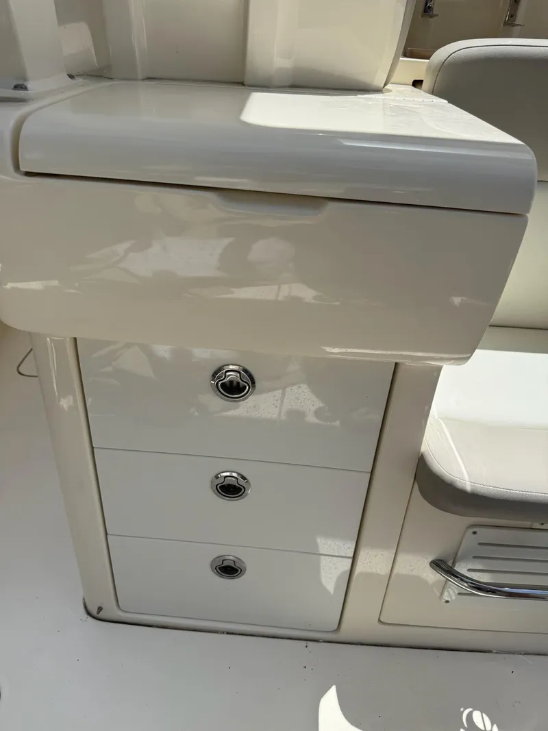 Slide: The Image of 2019 Scout 420 LXF boat interior with storage drawers and seating. - 46