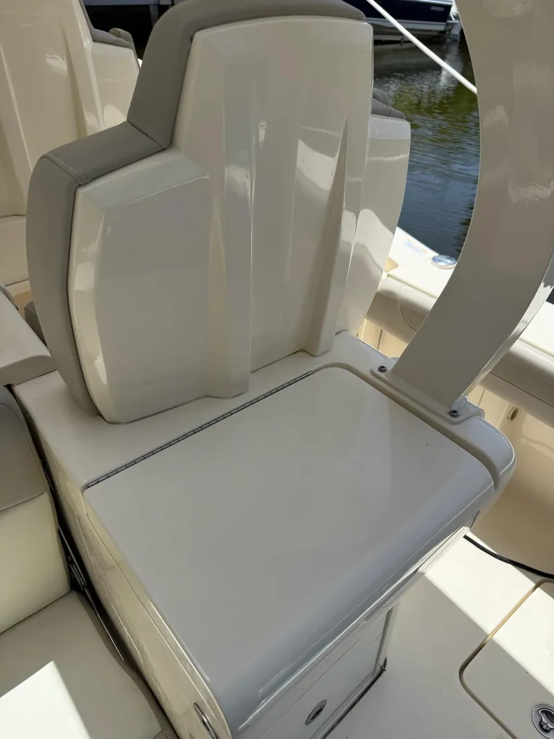 Slide: The Image of 2019 Scout 420 LXF boat interior seating, featuring sleek white upholstery and modern design. - 48