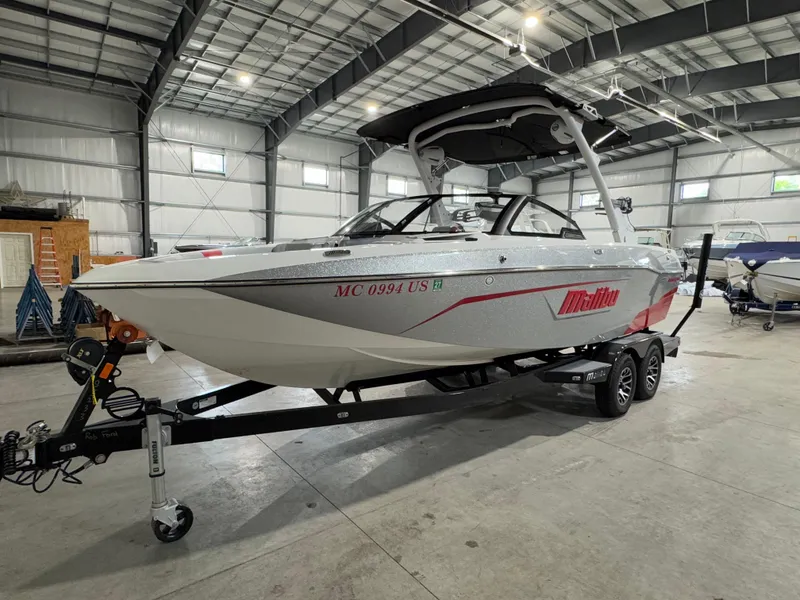 Slide: The Image of 2022 Malibu Wakesetter 23 LSV boat in a warehouse, on a trailer. - 1