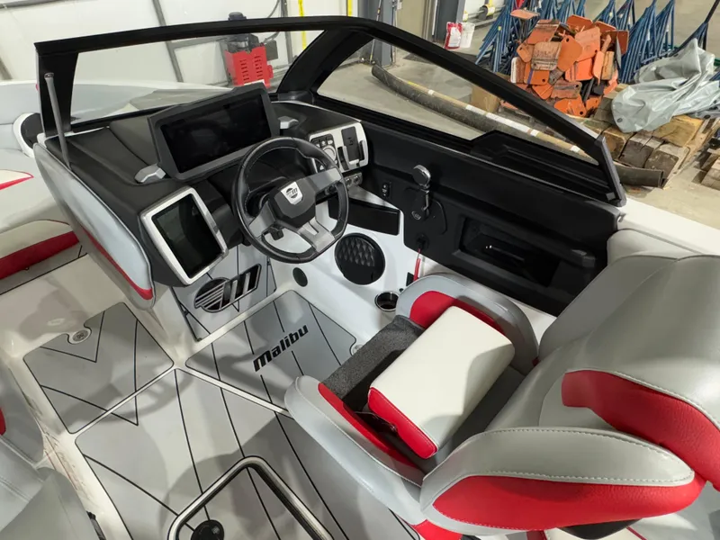 Slide: The Image of 2022 Malibu Wakesetter 23 LSV boat interior with modern dashboard and steering wheel. - 11