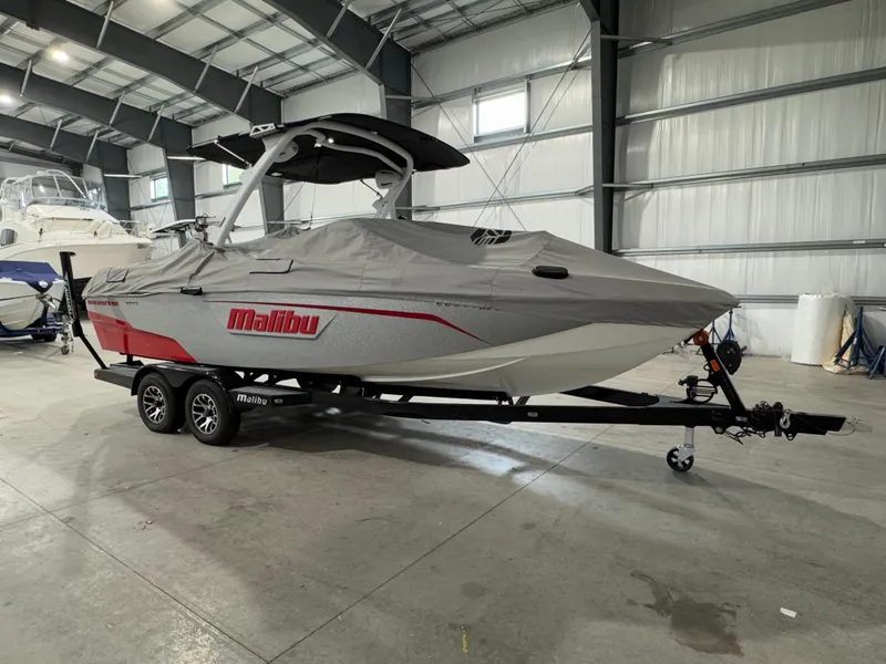 Slide: The Image of 2022 Malibu Wakesetter 23 LSV boat covered in a storage facility. - 2