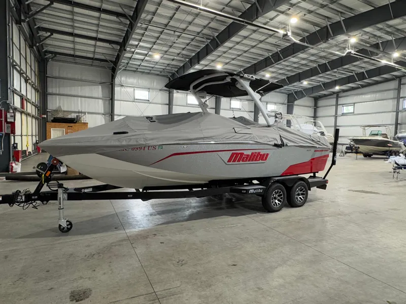 Slide: The Image of 2022 Malibu Wakesetter 23 LSV boat covered in a storage facility. - 3