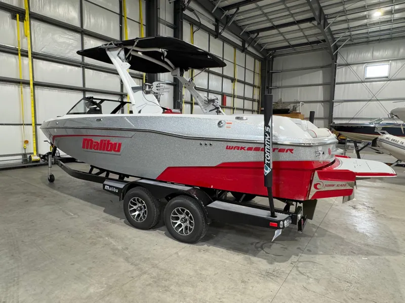 Slide: The Image of 2022 Malibu Wakesetter 23 LSV boat in a warehouse, silver and red design on trailer. - 4