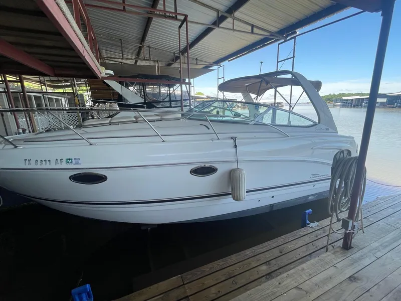 The Image of 2004 Chaparral Signature 290 boat docked under a covered marina. - 0