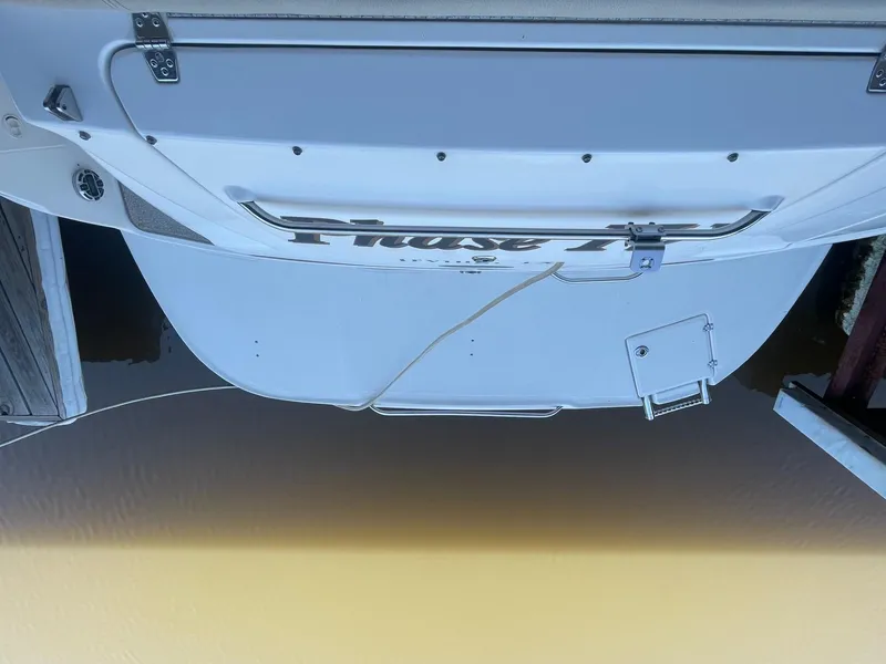 Slide: The Image of Rear view of a 2004 Chaparral Signature 290 boat docked on calm water. - 14